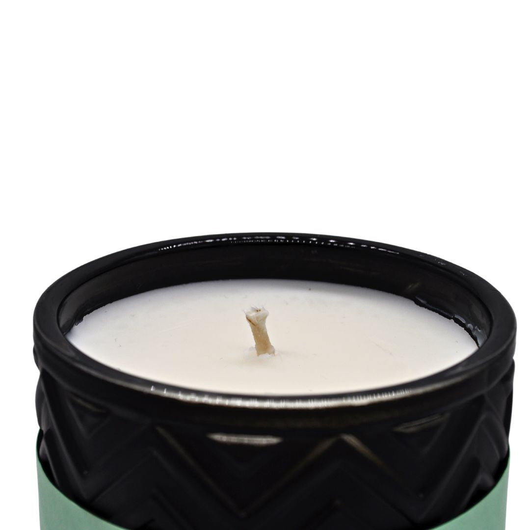 Wilde Sandalwood & Black Pepper Luxury Aromatherapy Scented Candle in an elegant glass jar with a flickering flame.