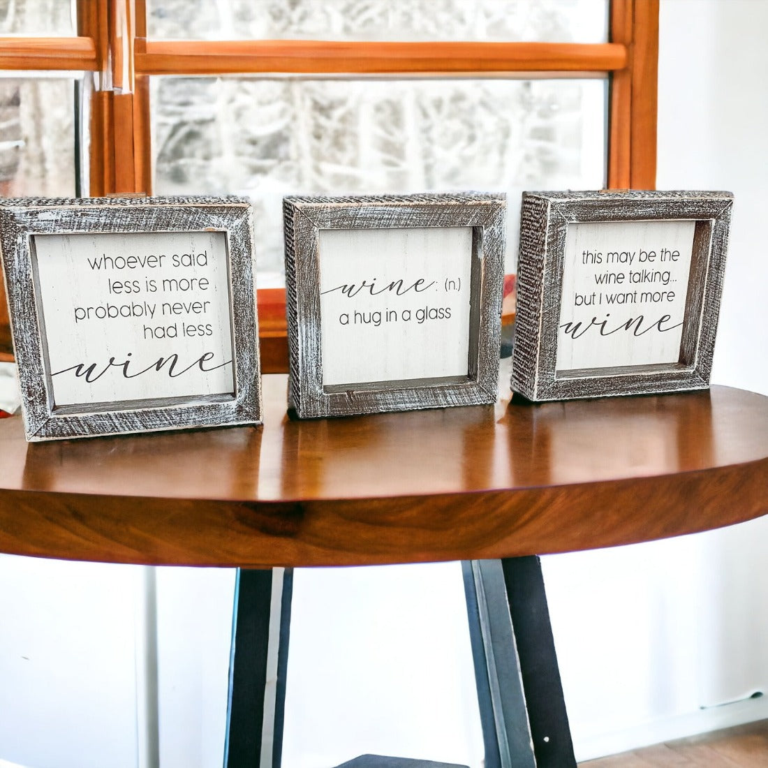 A beautifully framed wooden sign that reads 'Wine: A Hug', featuring a white-washed finish, perfect for home decor.