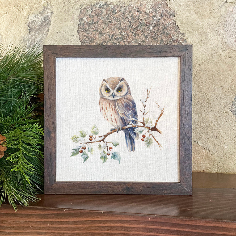 A beautifully framed sign featuring a winter owl design, set in a walnut veneer frame with a linen-look background.