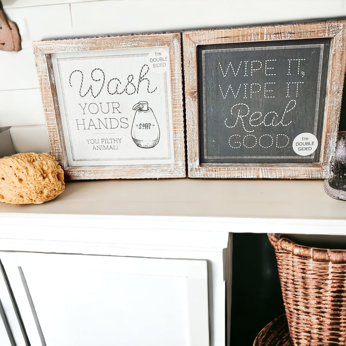 Wipe It Real Good Double-Sided sign with humorous bathroom messages in a wooden frame, displayed freestanding.