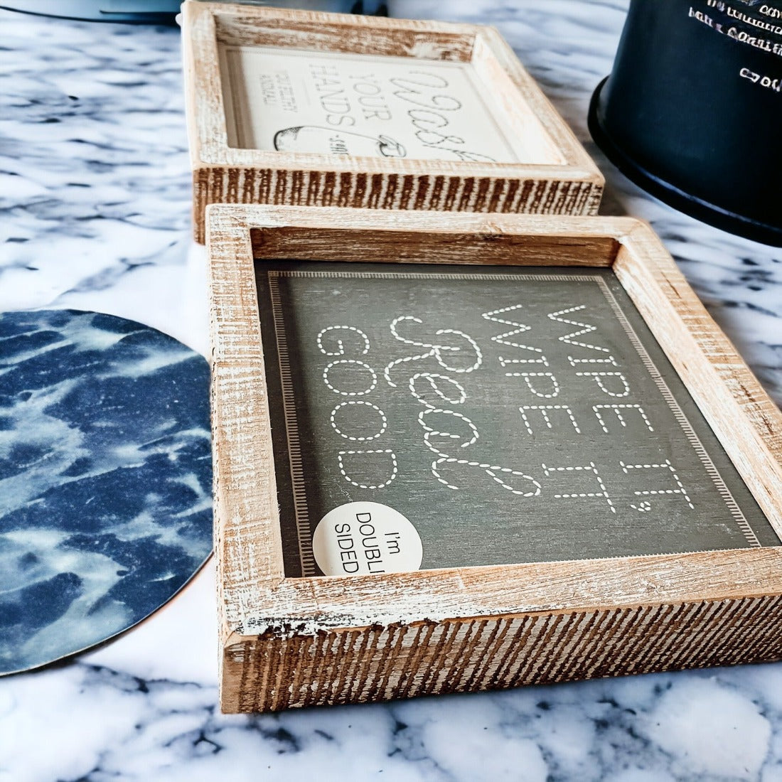 Wipe It Real Good Double-Sided sign with humorous bathroom messages in a wooden frame, displayed freestanding.
