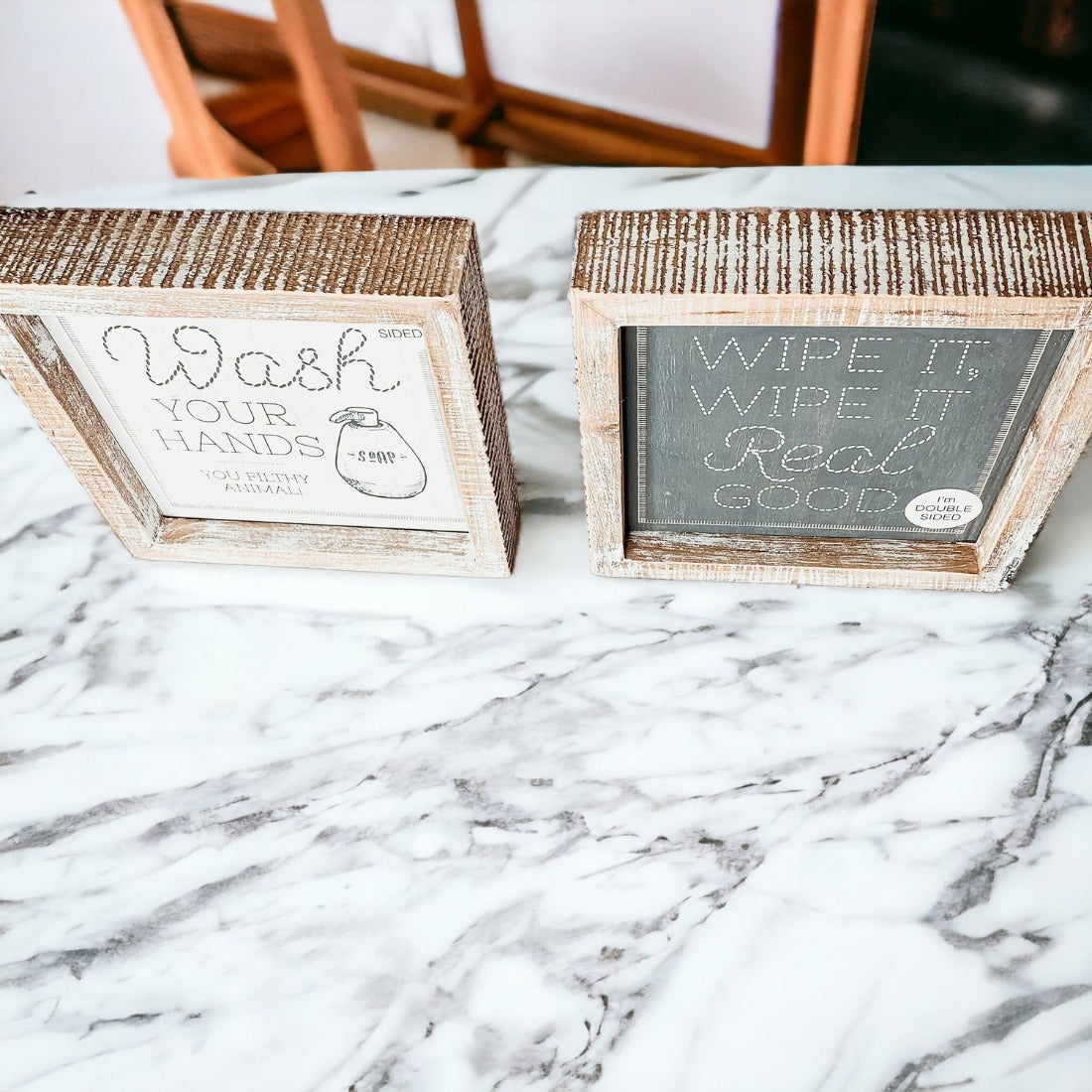 Wipe It Real Good Double-Sided sign with humorous bathroom messages in a wooden frame, displayed freestanding.