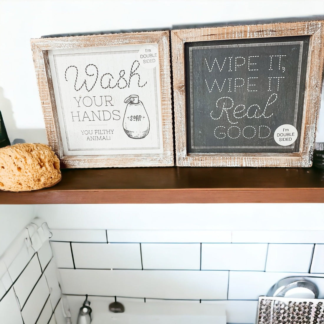 Wipe It Real Good Double-Sided sign with humorous bathroom messages in a wooden frame, displayed freestanding.