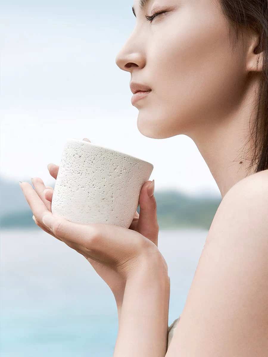 Wood Wick Soy Wax Scented Candle in a lava-like jar, featuring a refreshing snowy fir scent.