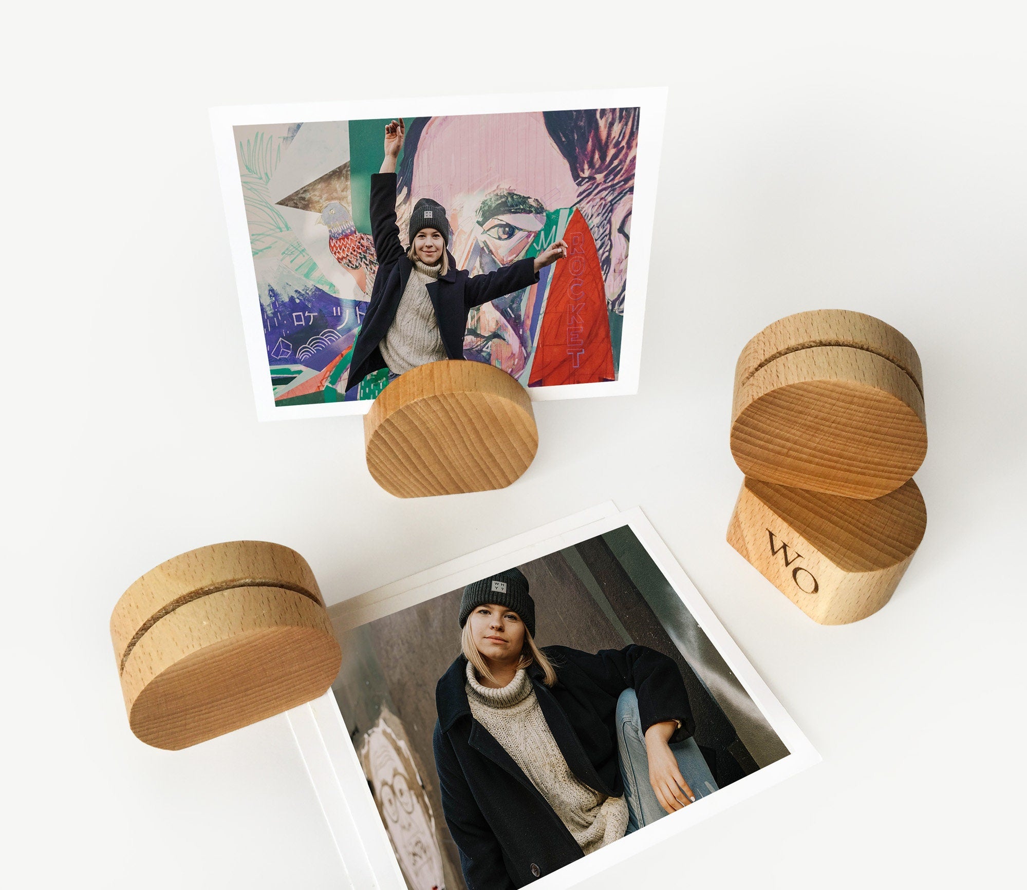 A handcrafted wooden moon card holder displaying various photos and art prints, showcasing its elegant design and eco-friendly material.