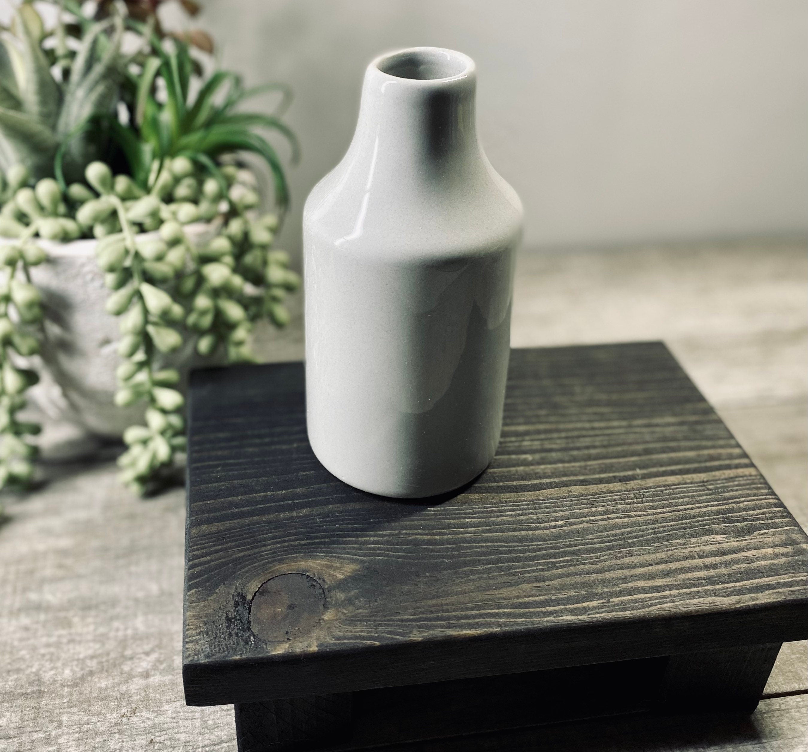 Handmade wooden riser in black stain, perfect for displaying soaps, candles, or plants, showcasing unique wood grain patterns.