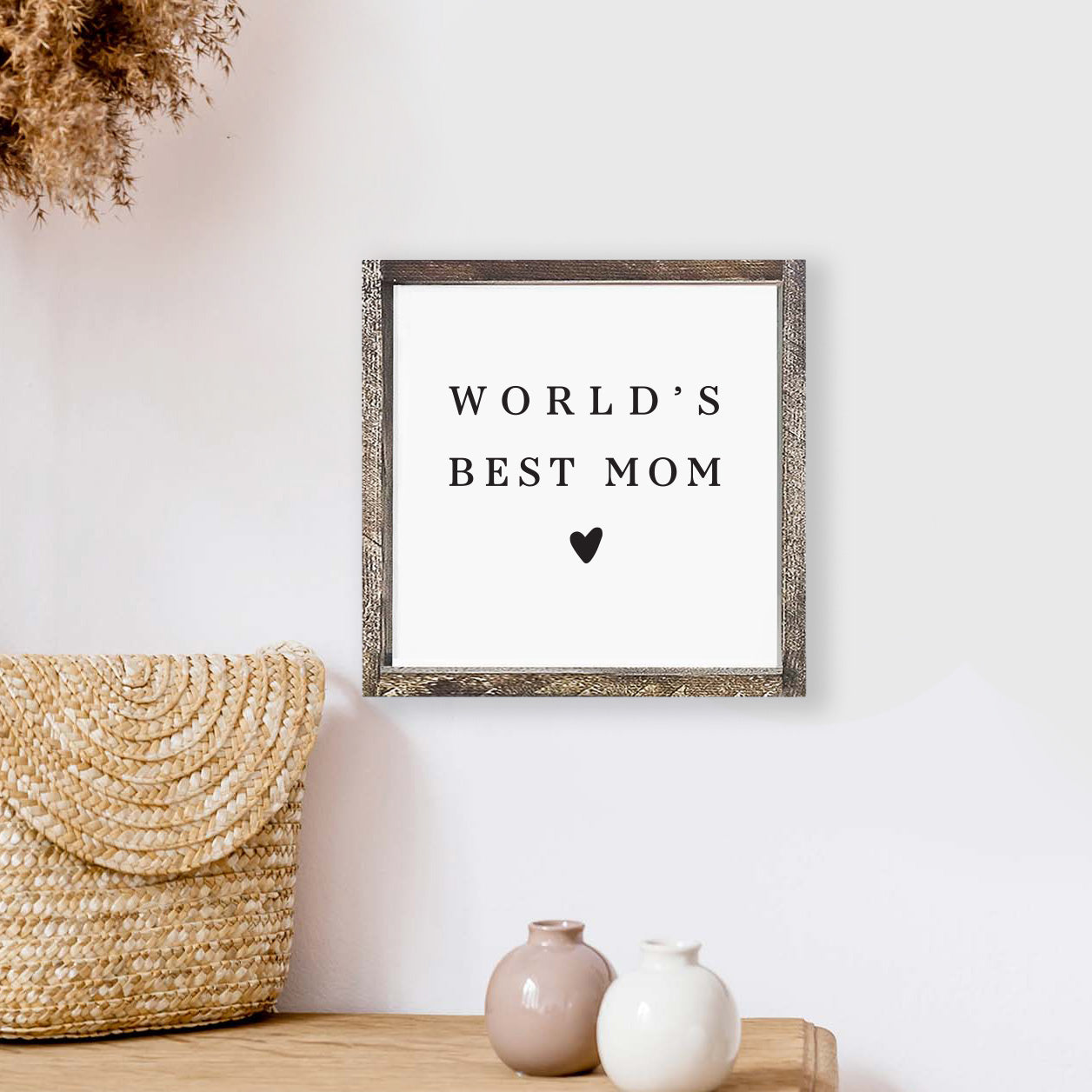 A beautifully crafted 8x8 inch wood sign that reads 'World's Best Mom', featuring a rustic pine wood frame and waterproof black text on a white background.