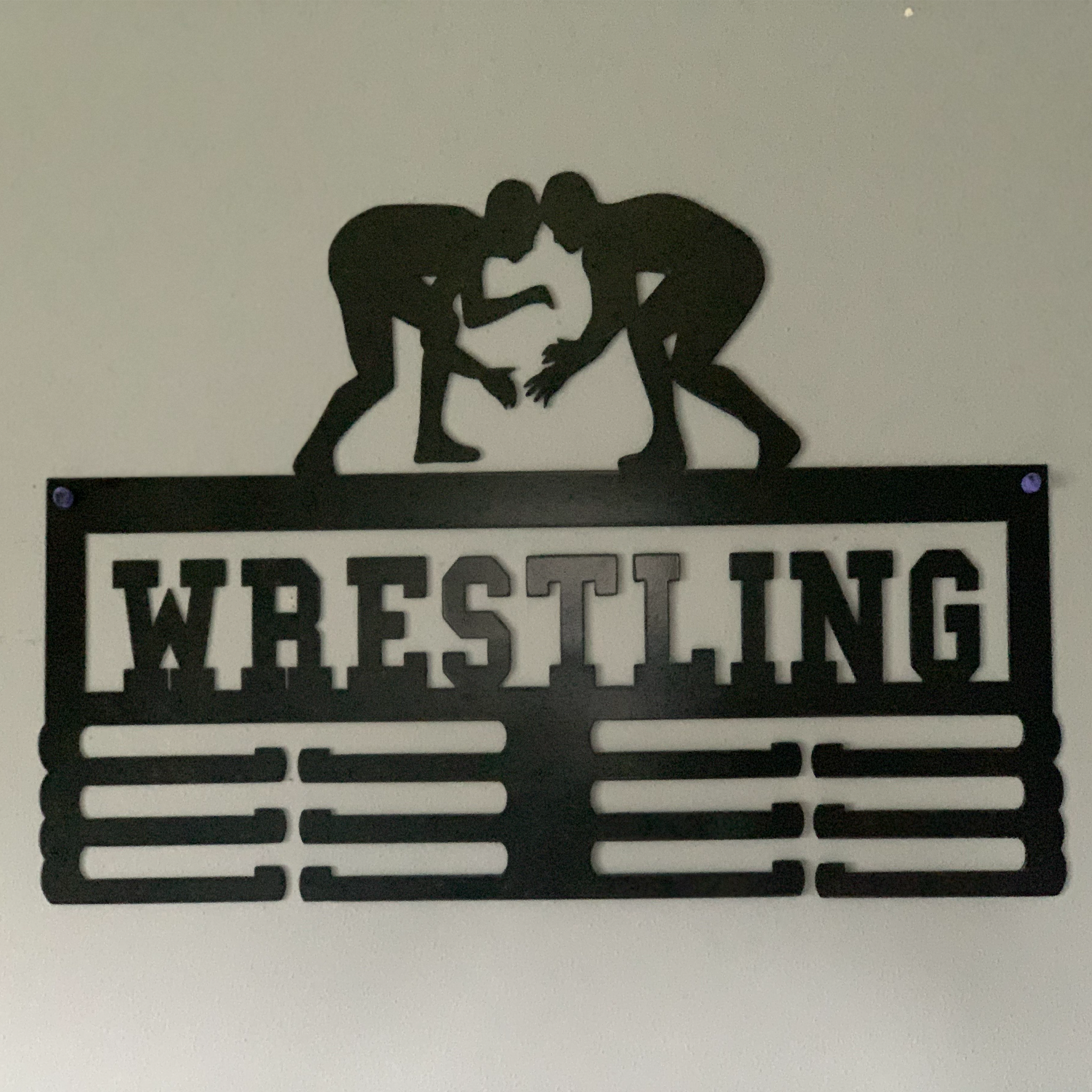 Wrestling Medal Holder made of durable 14 gauge steel, featuring hooks for displaying medals, with a sleek low gloss powder-coated finish.