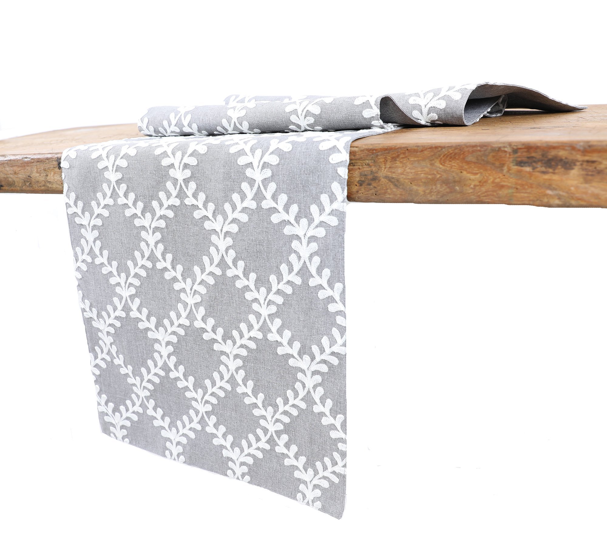 XD19200 Piluki Leaf Crewel Embroidered Table Runner featuring off-white leaves on textured gray fabric, elegantly designed for dining decor.