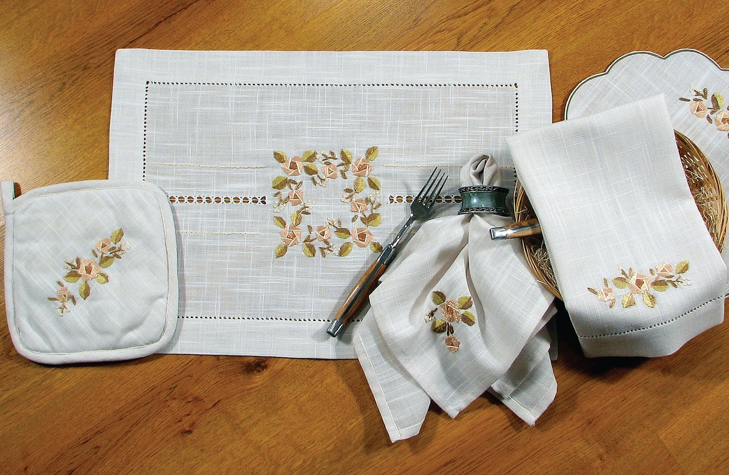 XD67801 Crewel Rose Collection featuring elegant flower embroidery and hand-rendered cutwork on table linens.