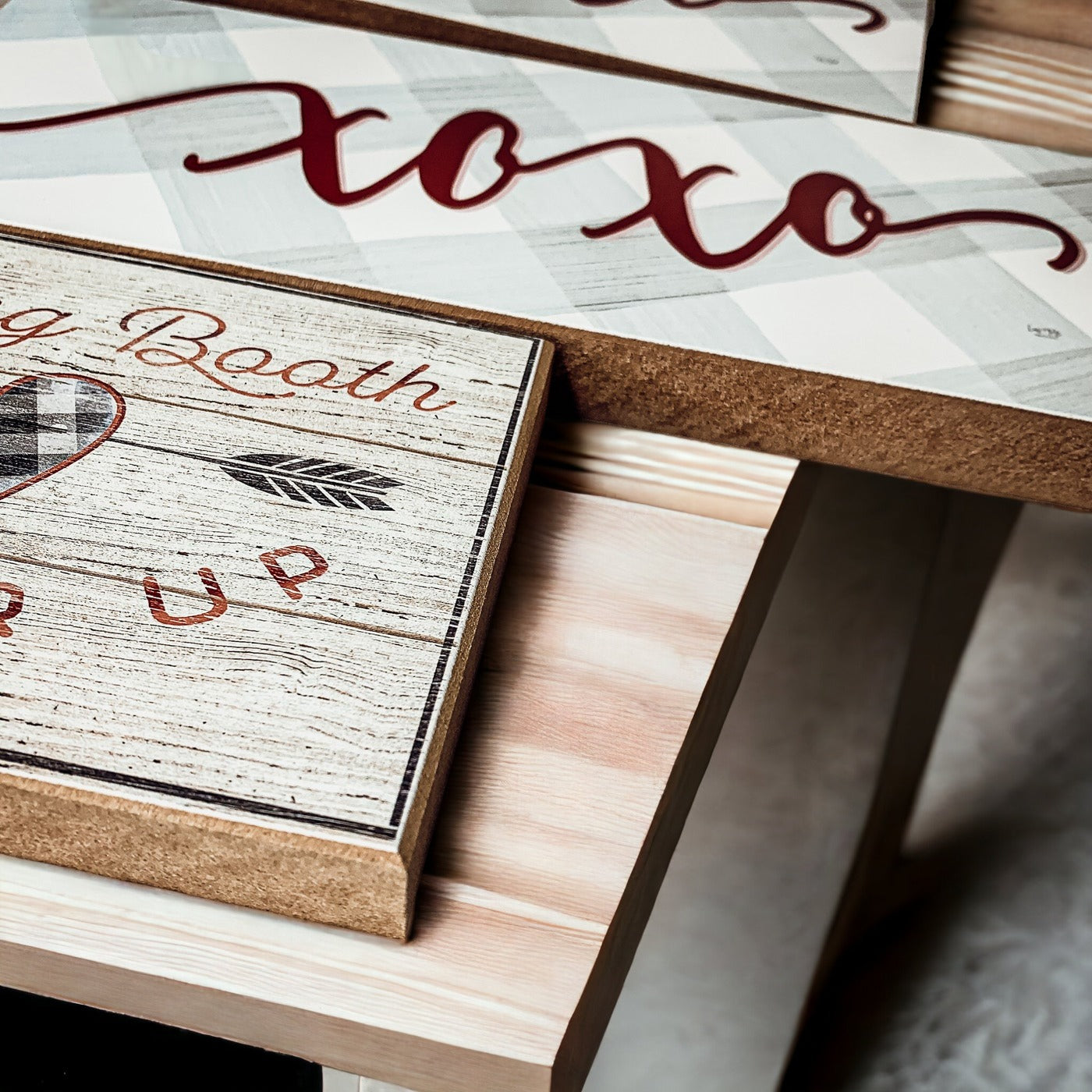 Handmade XOXO Sign made of thick wood with a light gray and white checkered background and darker red script, perfect for Valentine's Day decor.