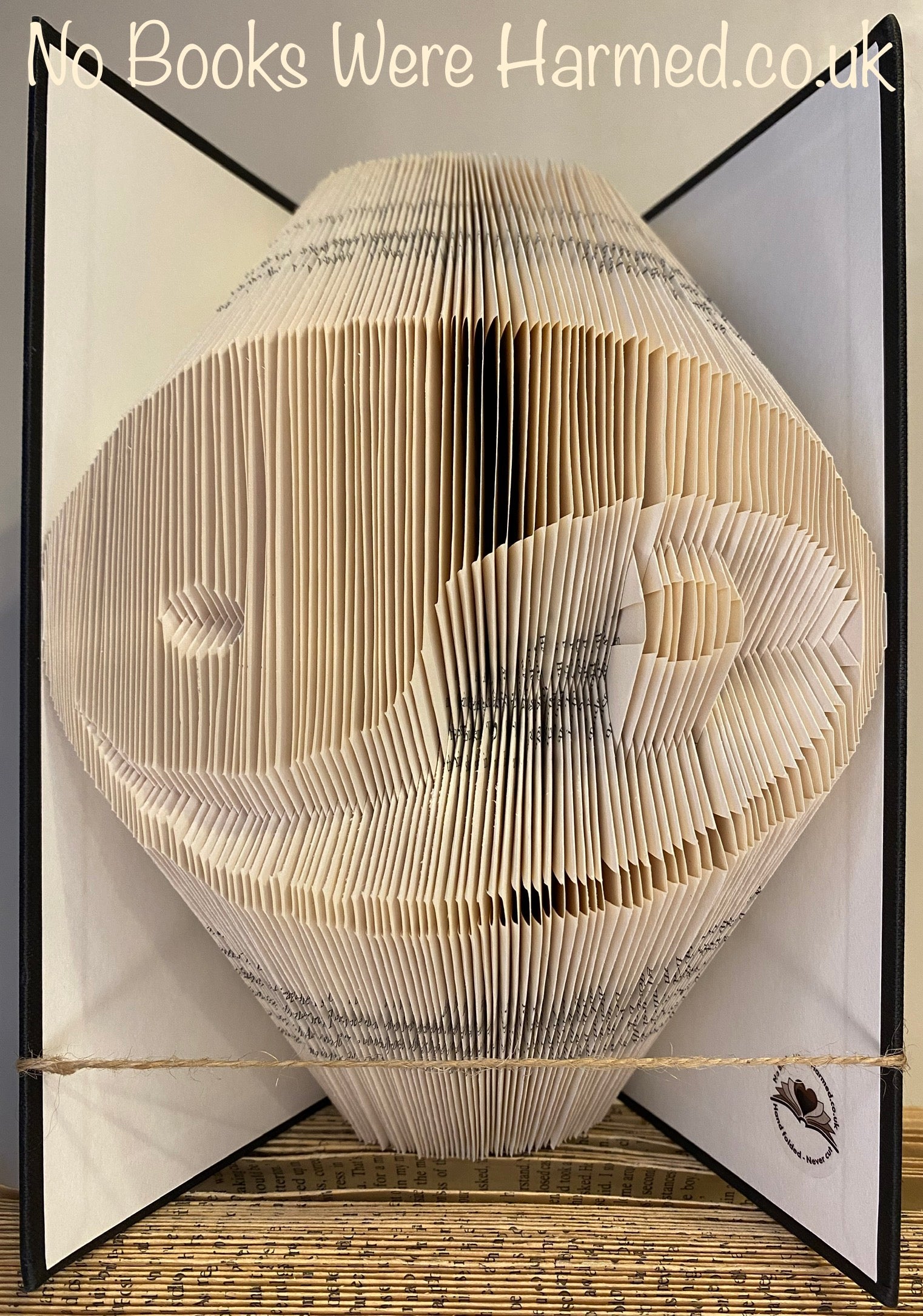 Handcrafted Yin and Yang book art made from vintage pages, showcasing intricate folds and unique design.