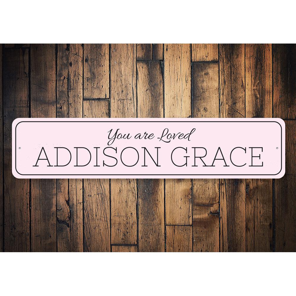 A beautifully crafted 'You Are Loved' metal sign, showcasing a warm and inviting design, perfect for home decor.