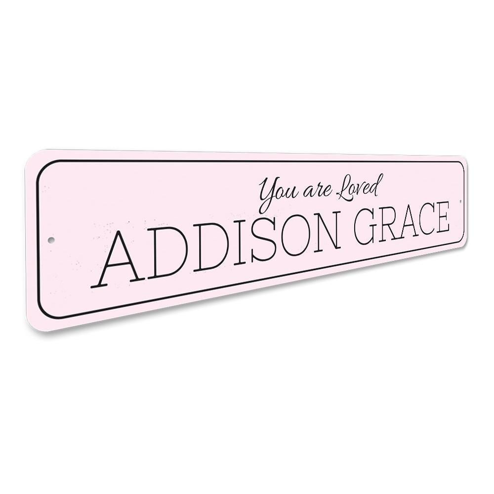 A beautifully crafted 'You Are Loved' metal sign, showcasing a warm and inviting design, perfect for home decor.