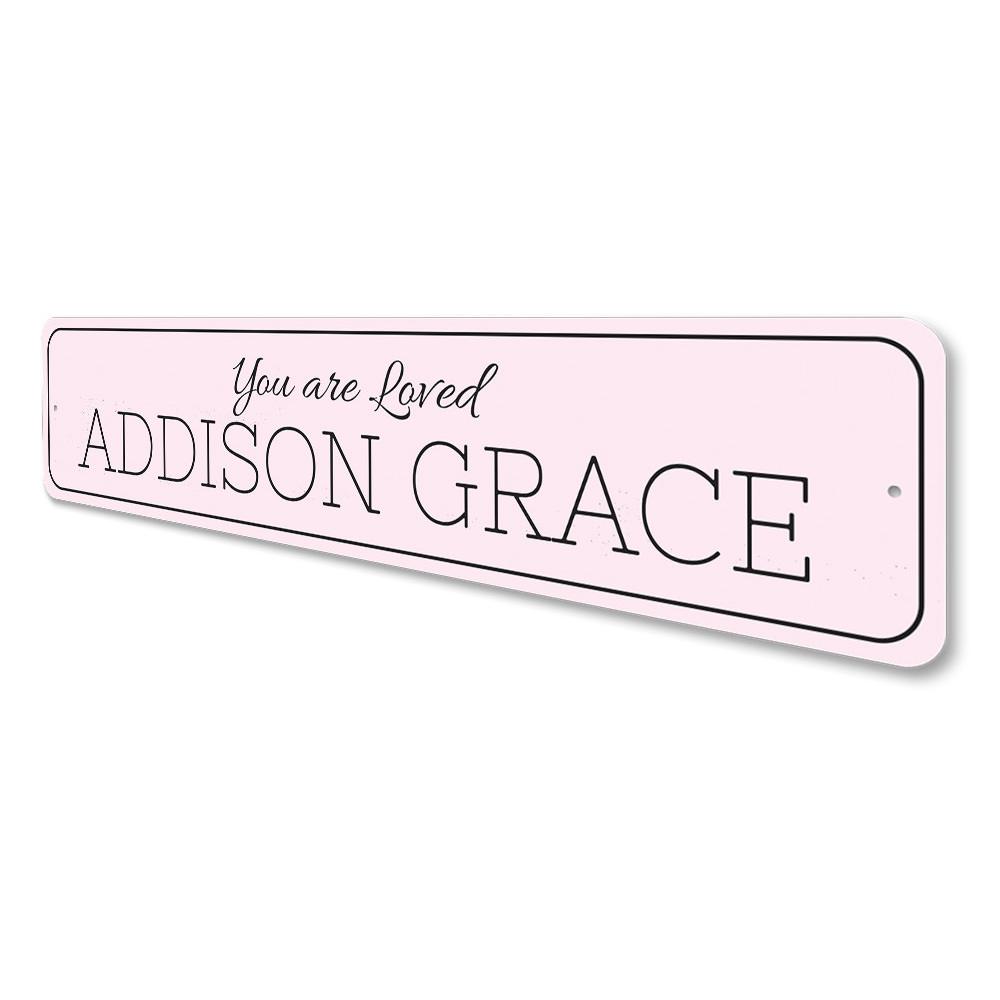 A beautifully crafted 'You Are Loved' metal sign, showcasing a warm and inviting design, perfect for home decor.