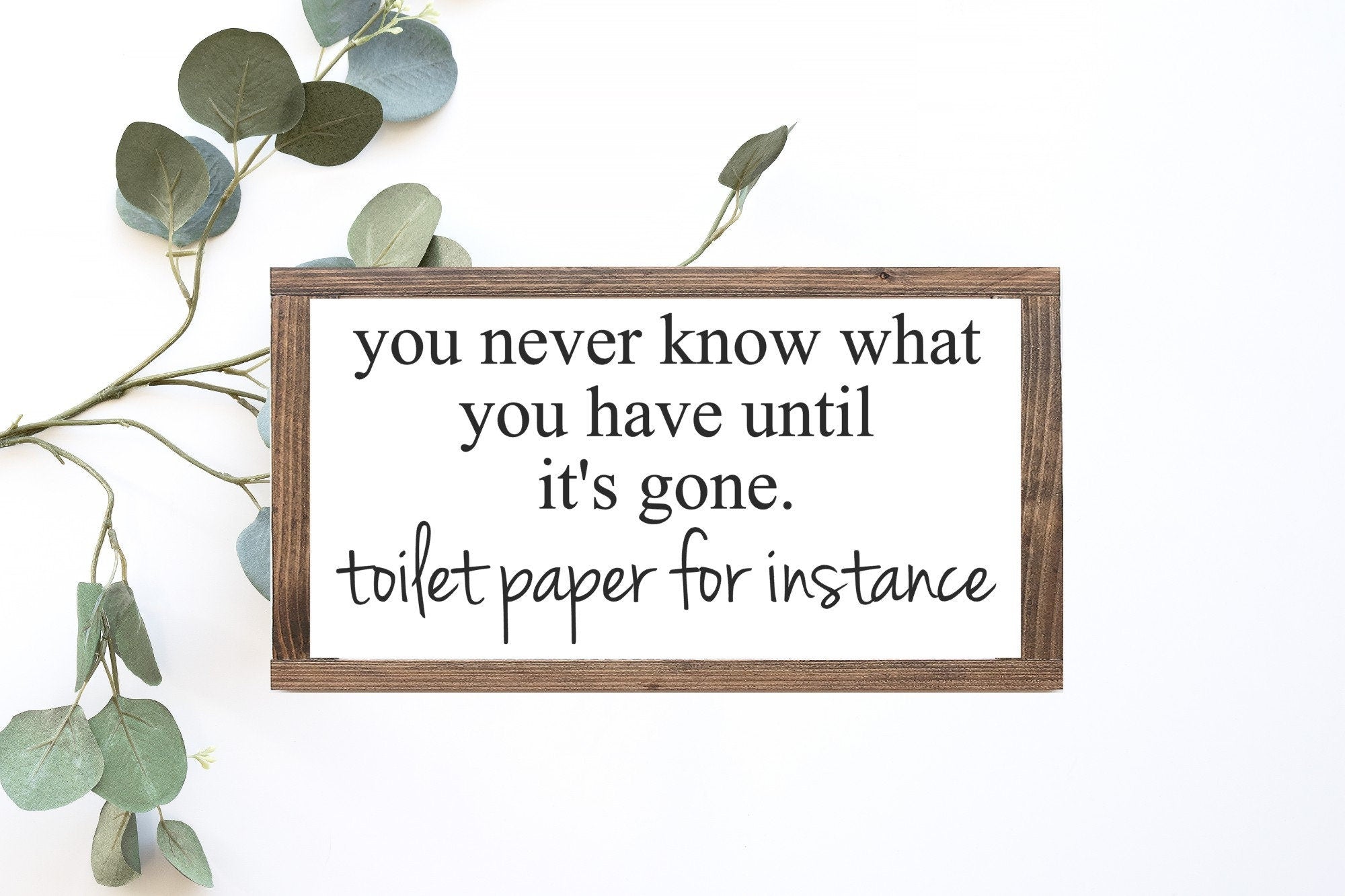 Handmade wooden toilet paper sign with white matte finish and humorous lettering, perfect for bathroom decor.