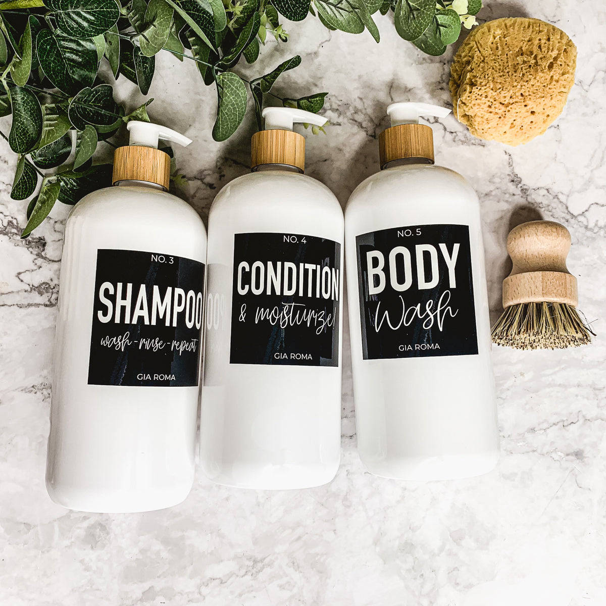 A set of 32oz plastic white dispensers with waterproof labels, featuring a black pump and a white flip cap, ideal for home and office use.