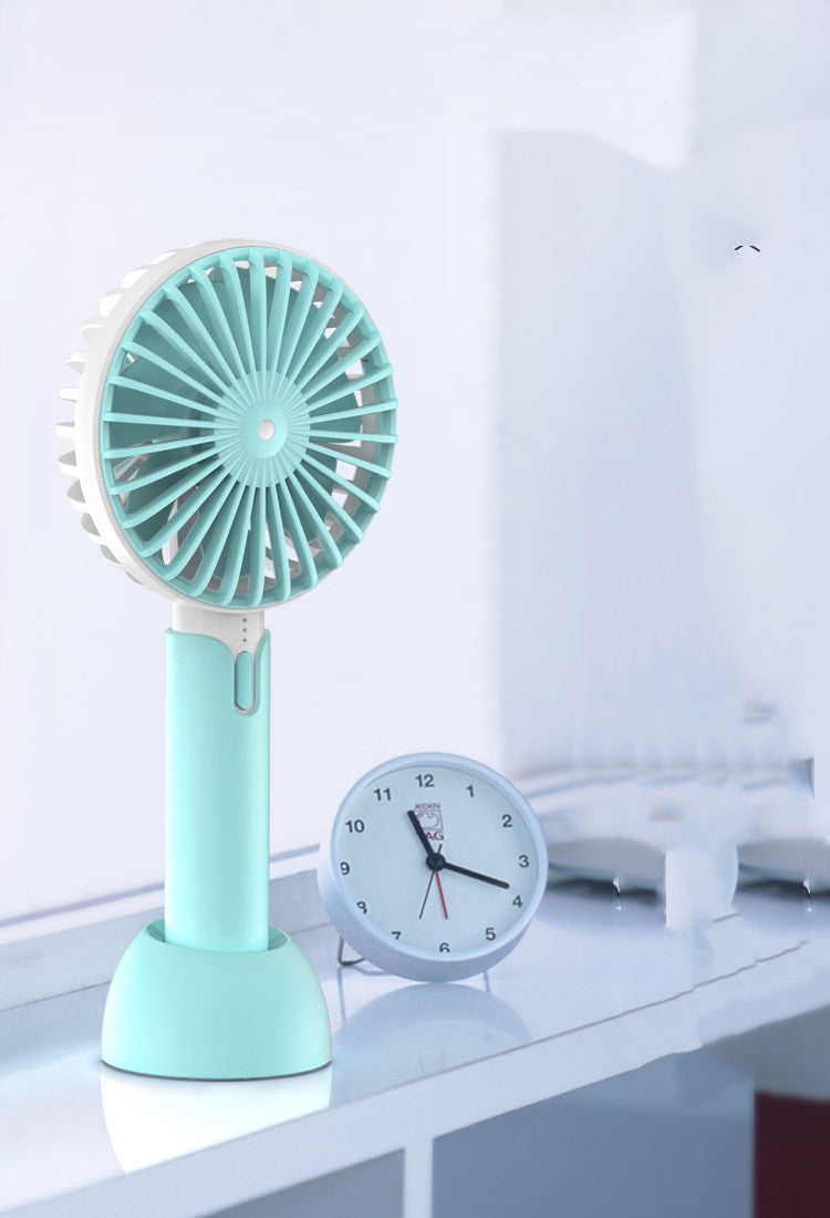A compact Handheld Mini Silent Desktop Small Electric Fan in a stylish design, showcasing its USB power supply and three-speed control settings.