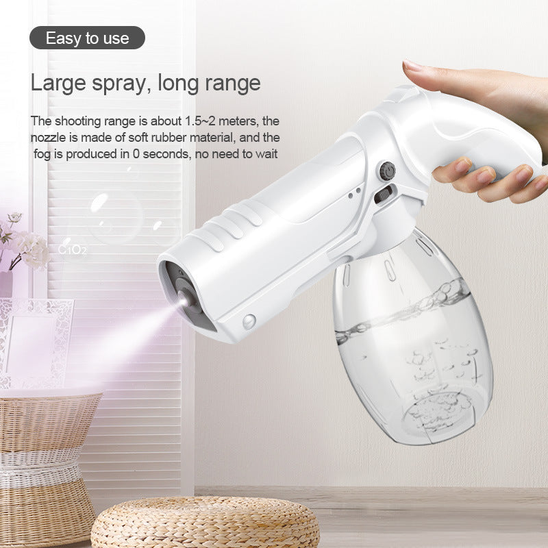 Handheld Wireless Charging Blue Light Nano Atomizing Spray Gun with a sleek white design, showcasing its nozzle and water bottle.