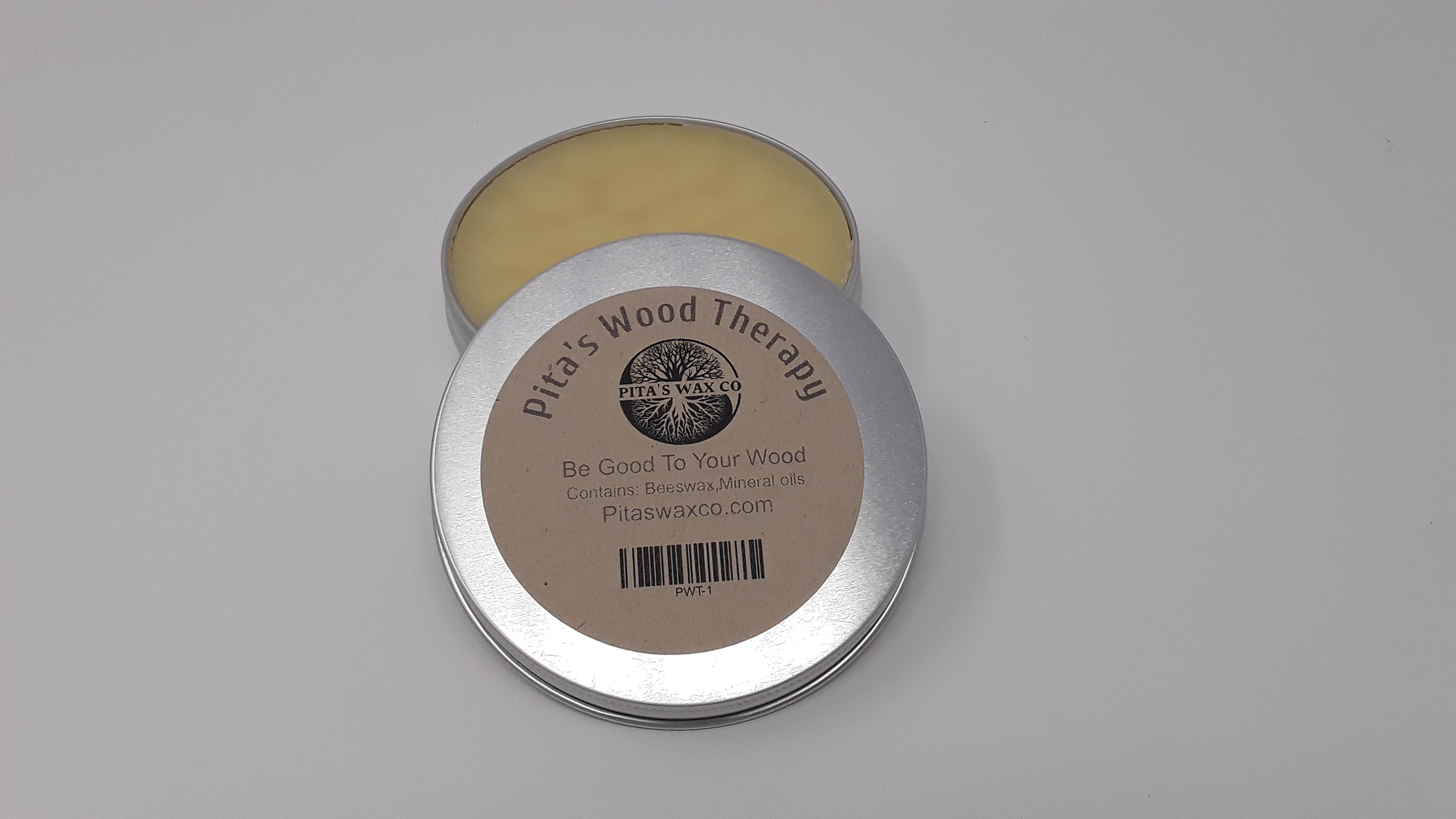 Pita's Wood Therapy Best Wood Wax jar with a wooden spoon and cutting board in the background, showcasing its natural ingredients.