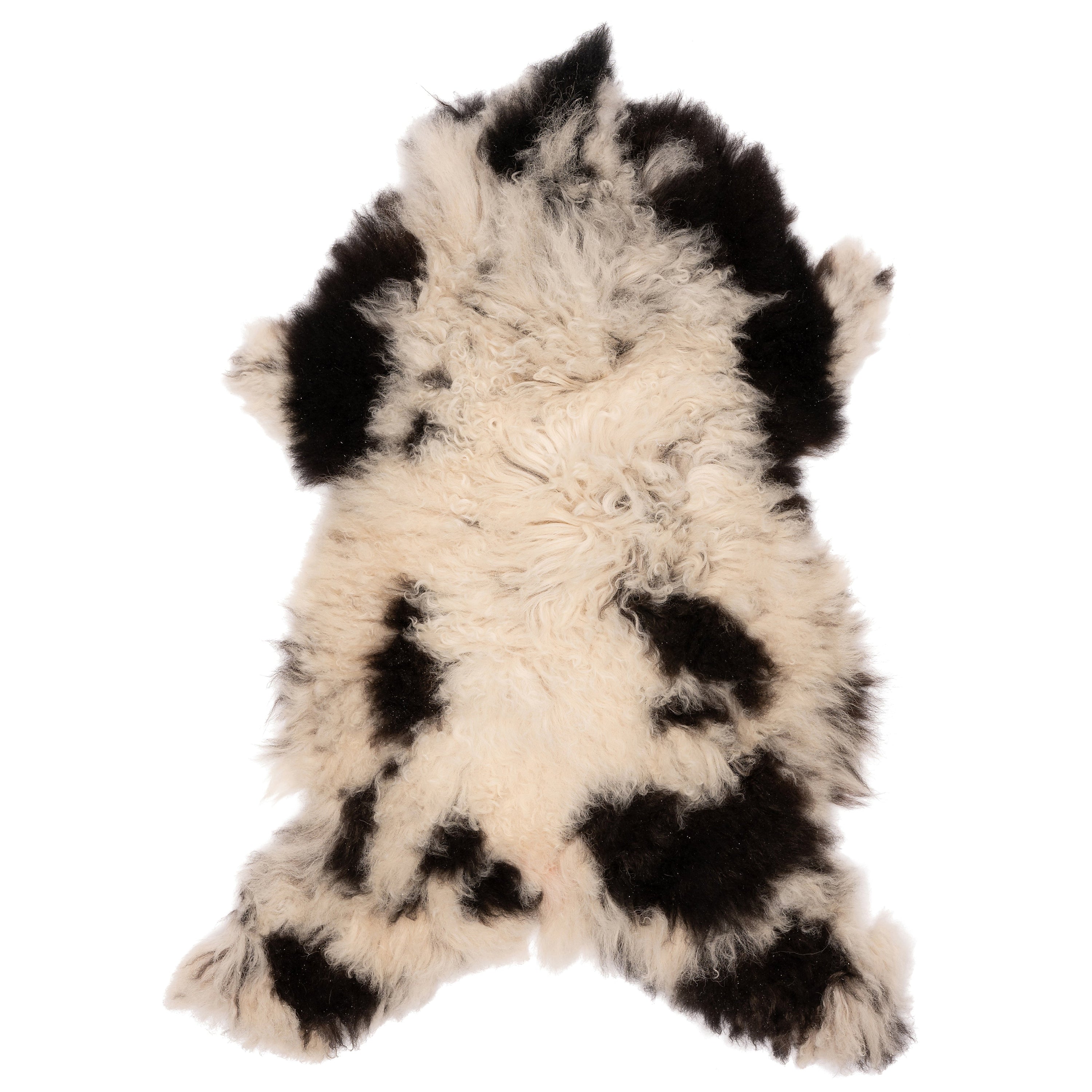 Unieke zwart-witte schapenvacht van 90 x 50 cm, zacht en natuurlijk, perfect voor decoratie en comfort in huis.