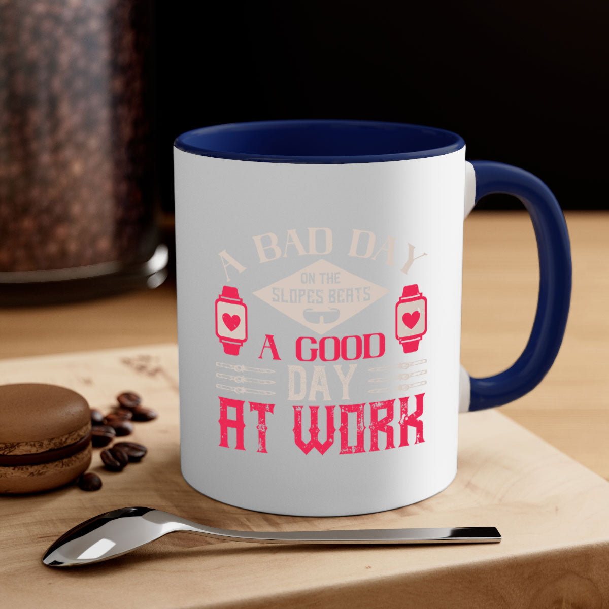 A stylish two-tone ceramic mug with the phrase 'A bad day on the slopes beats a good day at work' printed on it, featuring a colored handle and glossy finish.