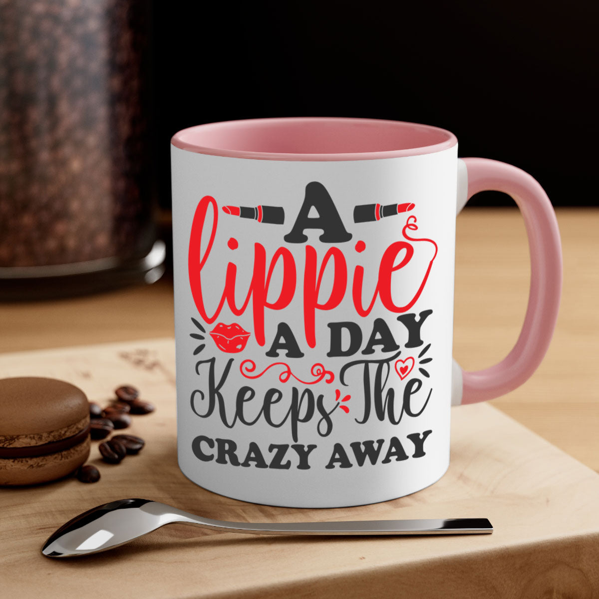 Two-tone ceramic coffee mug with colorful handle and interior, featuring the phrase 'a lippie a day keeps the crazyaway'.