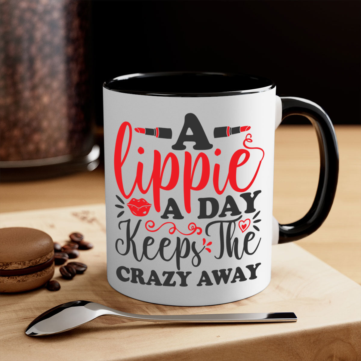 Two-tone ceramic coffee mug with colorful handle and interior, featuring the phrase 'a lippie a day keeps the crazyaway'.