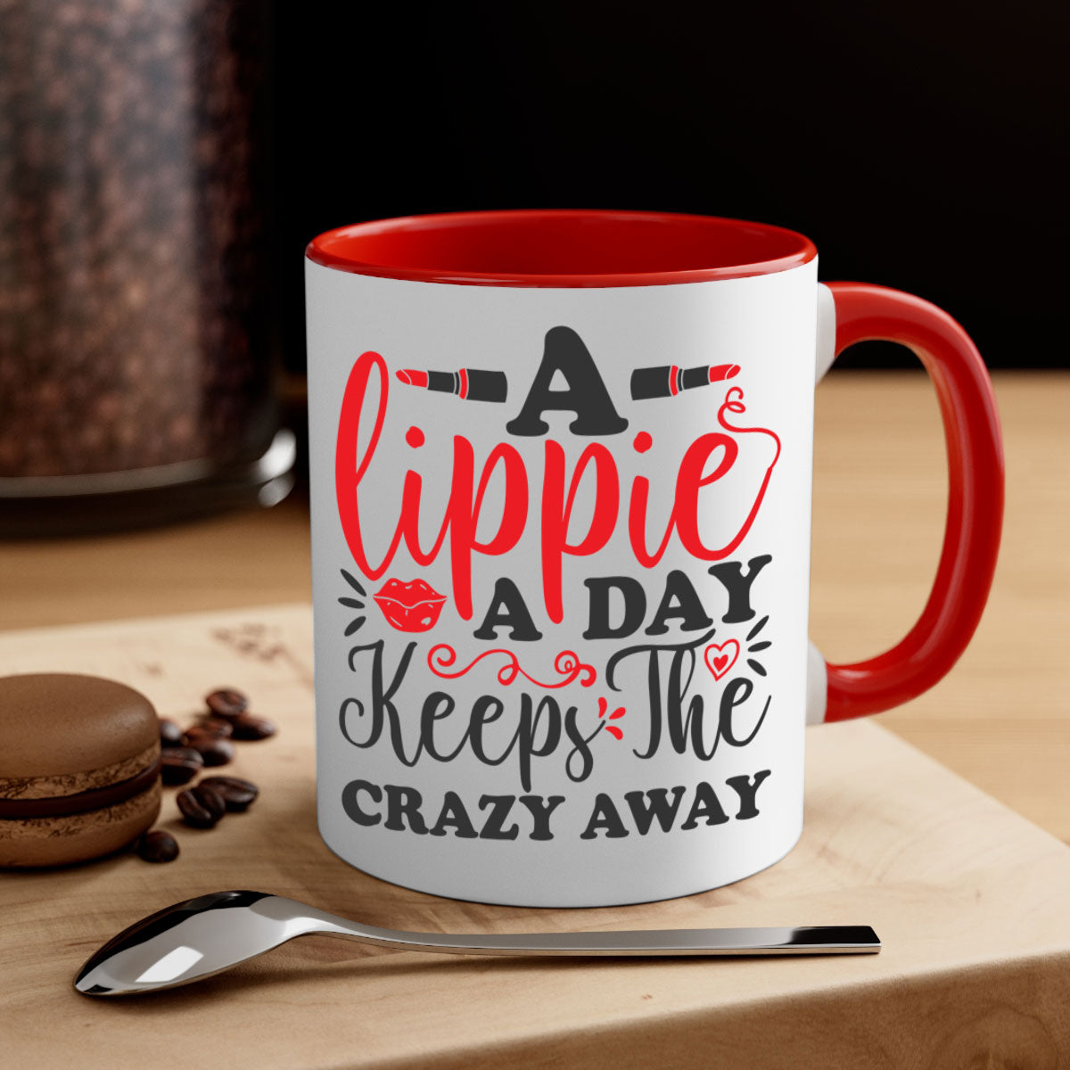 Two-tone ceramic coffee mug with colorful handle and interior, featuring the phrase 'a lippie a day keeps the crazyaway'.