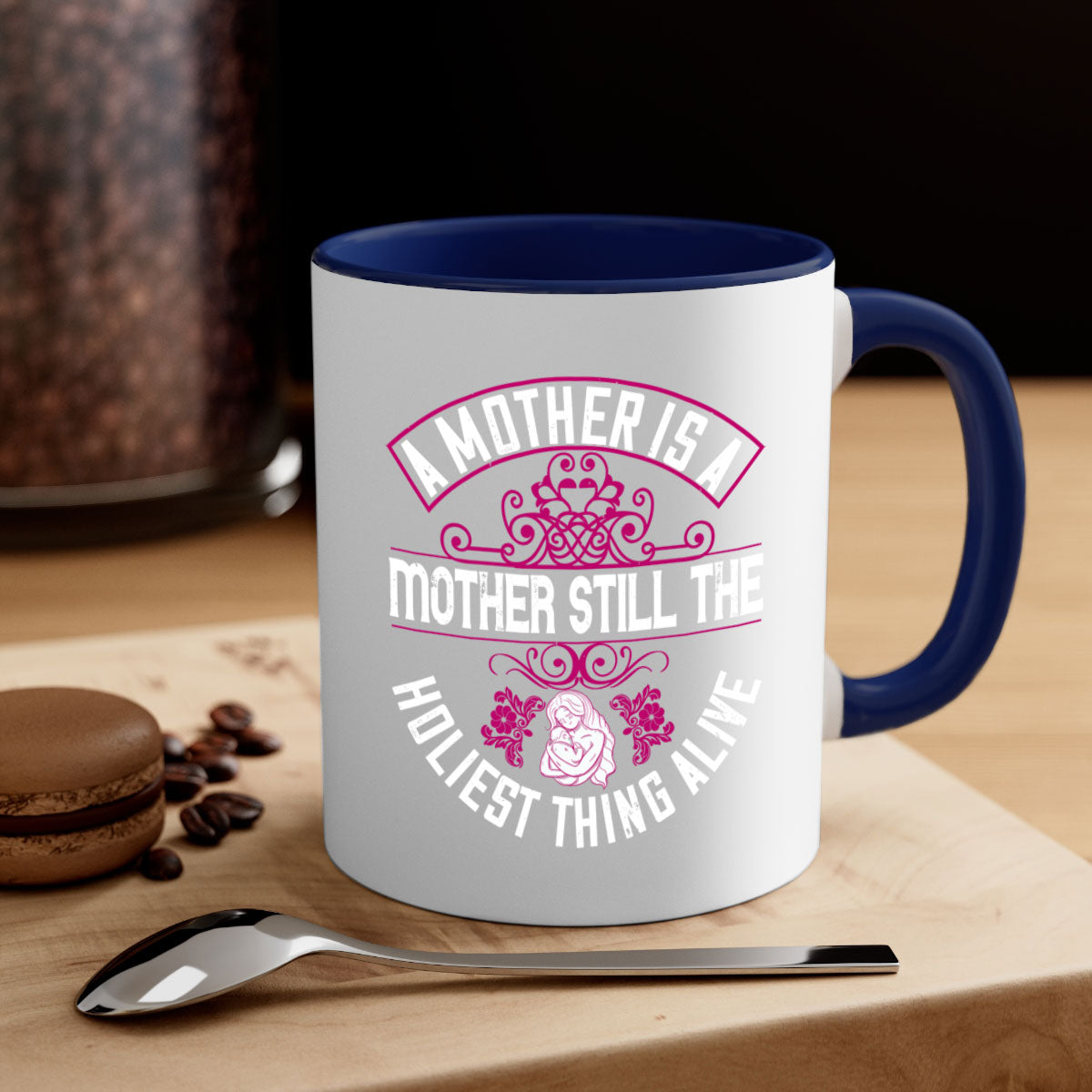 A stylish two-tone ceramic mug with a colored handle and interior, featuring the phrase 'A Mother is a Mother Still the Holiest Thing Alive'.