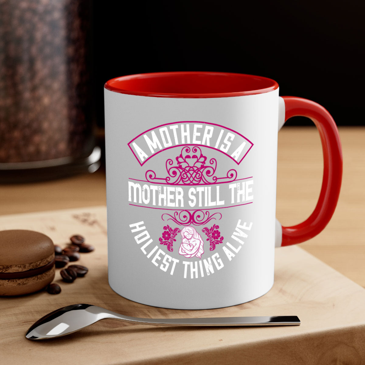 A stylish two-tone ceramic mug with a colored handle and interior, featuring the phrase 'A Mother is a Mother Still the Holiest Thing Alive'.