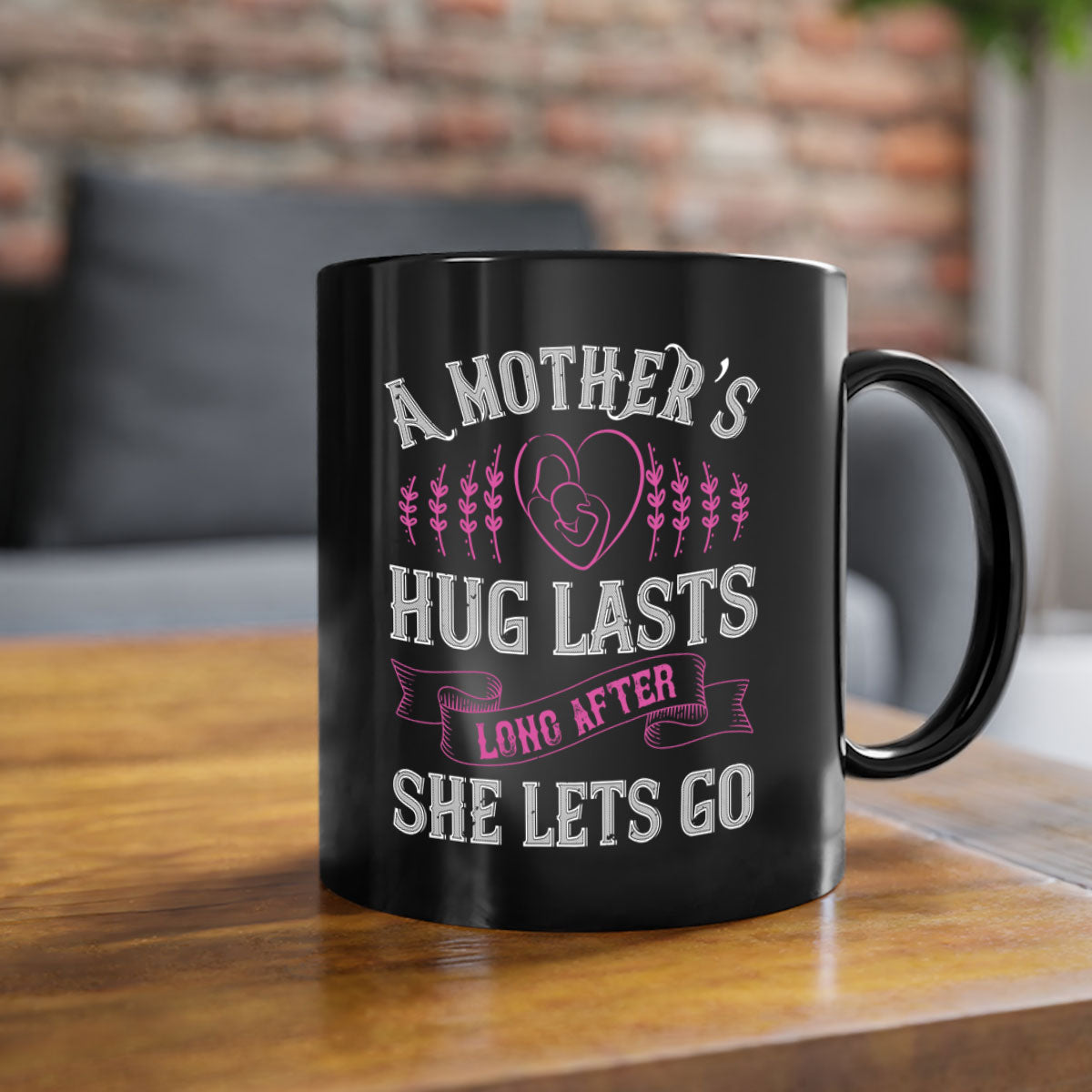 Ceramic coffee mug with a two-tone design featuring a colored handle and interior, showcasing the phrase 'A Mother’s Hug Lasts Long After She Lets Go'.
