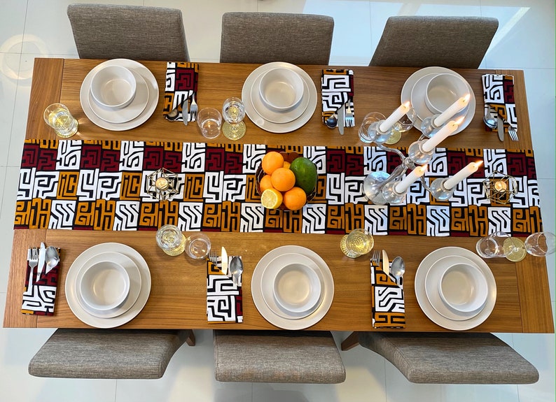 African MudCloth Table Runner with six matching napkins, featuring a vibrant tribal design in black, white, burgundy red, and orange.