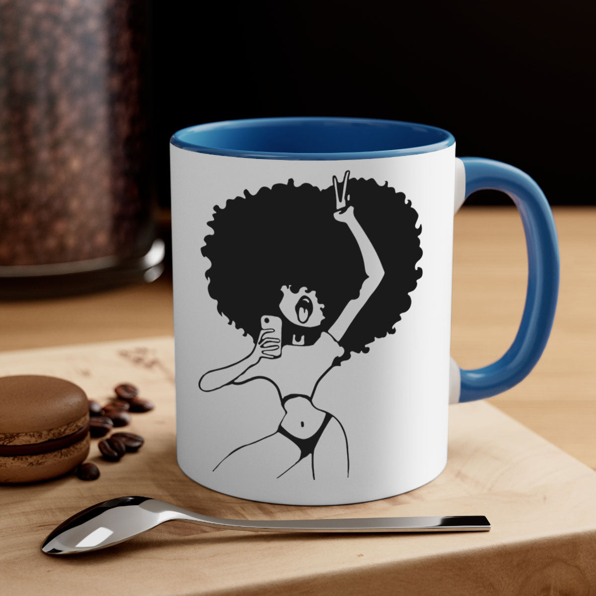 A stylish coffee mug featuring an afro woman taking a selfie, with a glossy finish and a colored handle.