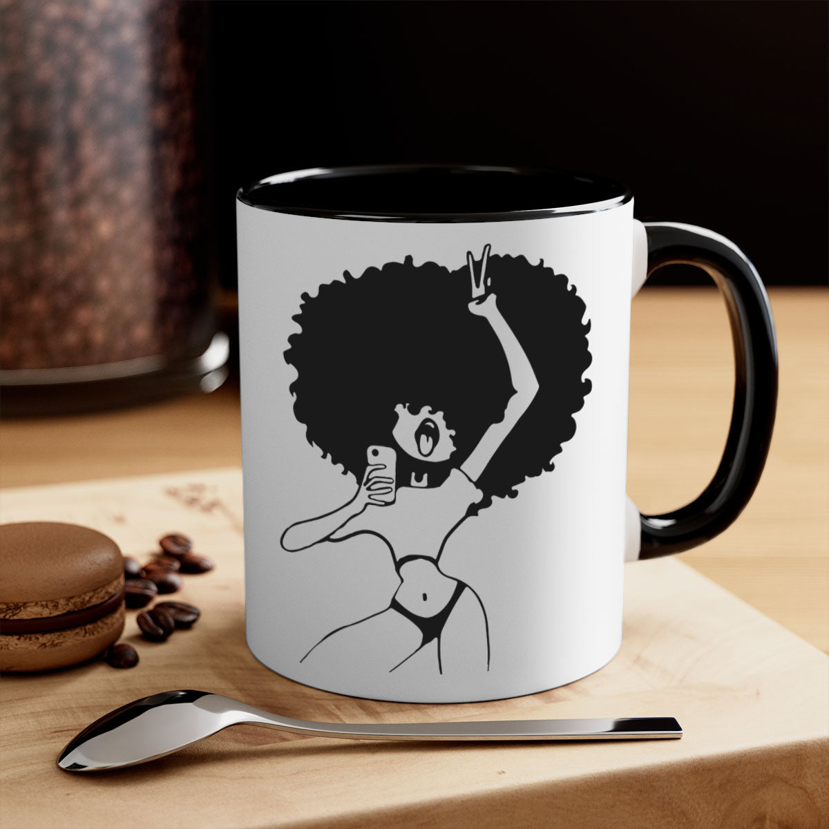 A stylish coffee mug featuring an afro woman taking a selfie, with a glossy finish and a colored handle.