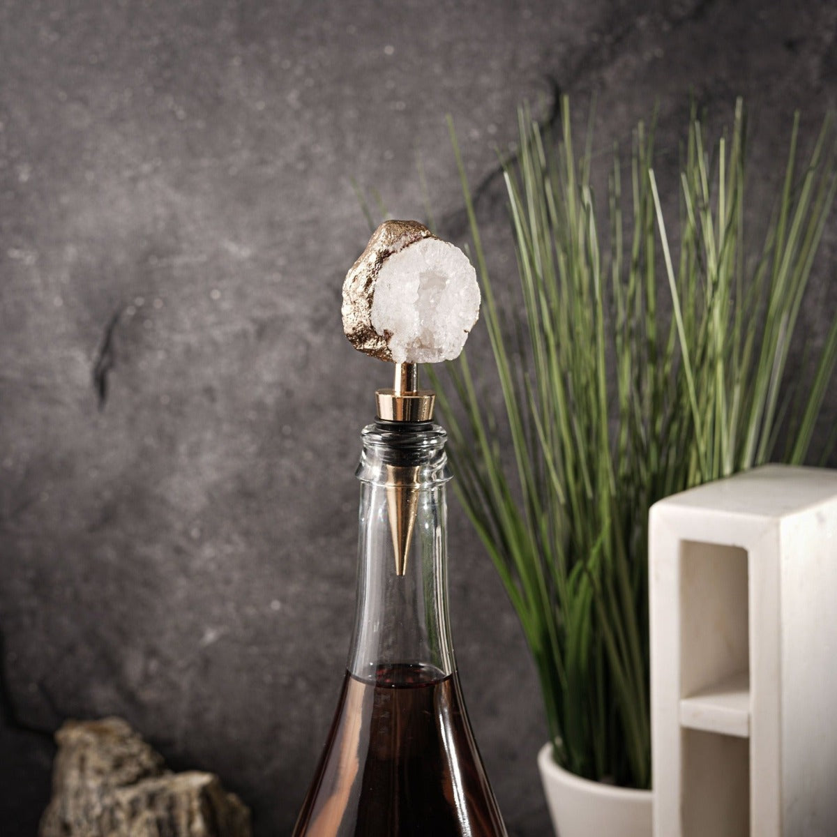 Agate Crystal Bottle Stopper in two colors, showcasing a unique geode design with a gold or silver plated edge.