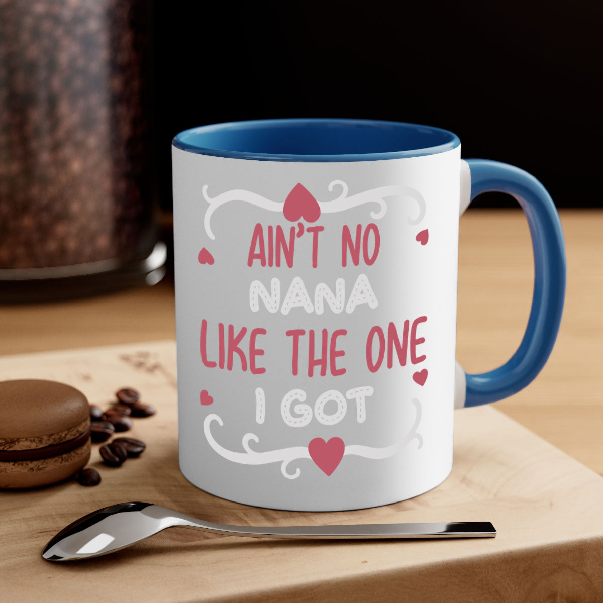 A stylish two-tone ceramic mug with a colored handle and interior, featuring the phrase 'Ain’t No Nana Like The One I Got'.