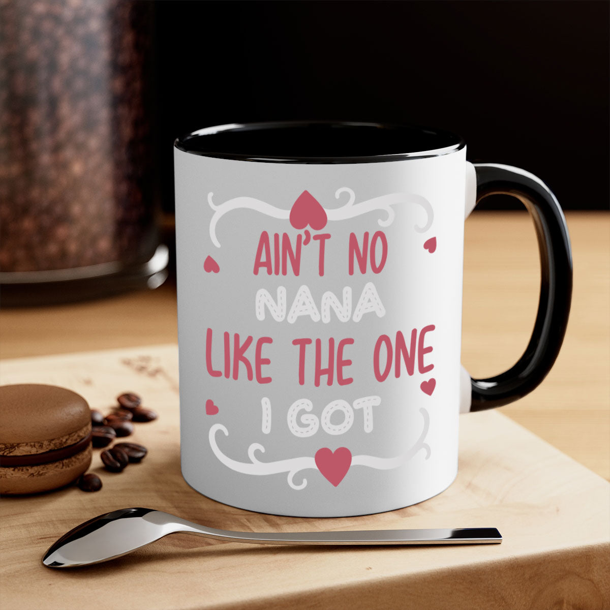 A stylish two-tone ceramic mug with a colored handle and interior, featuring the phrase 'Ain’t No Nana Like The One I Got'.