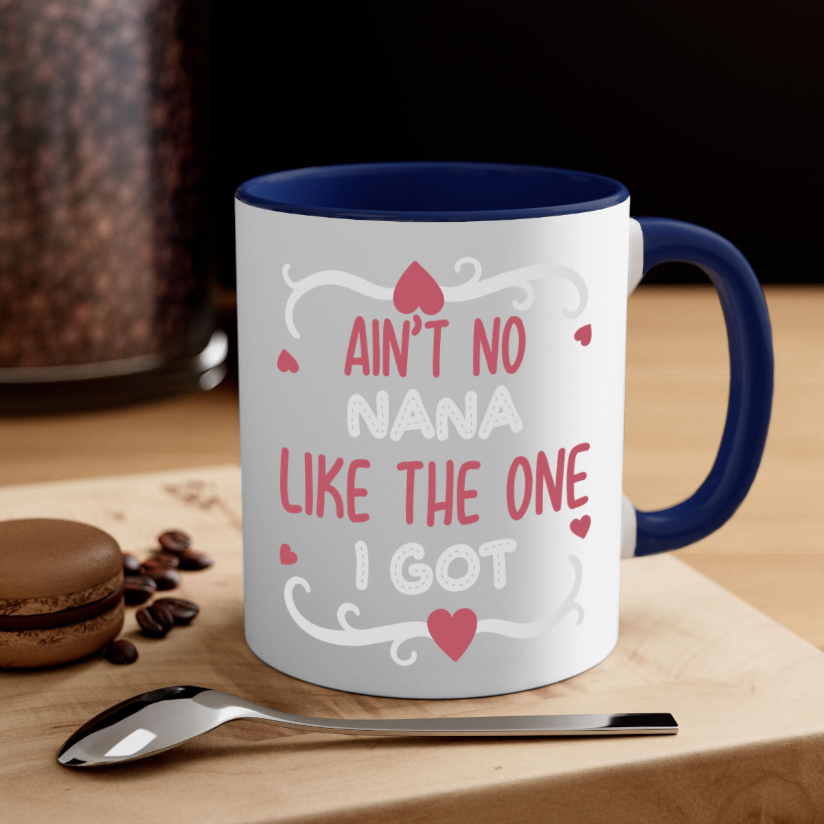 A stylish two-tone ceramic mug with a colored handle and interior, featuring the phrase 'Ain’t No Nana Like The One I Got'.