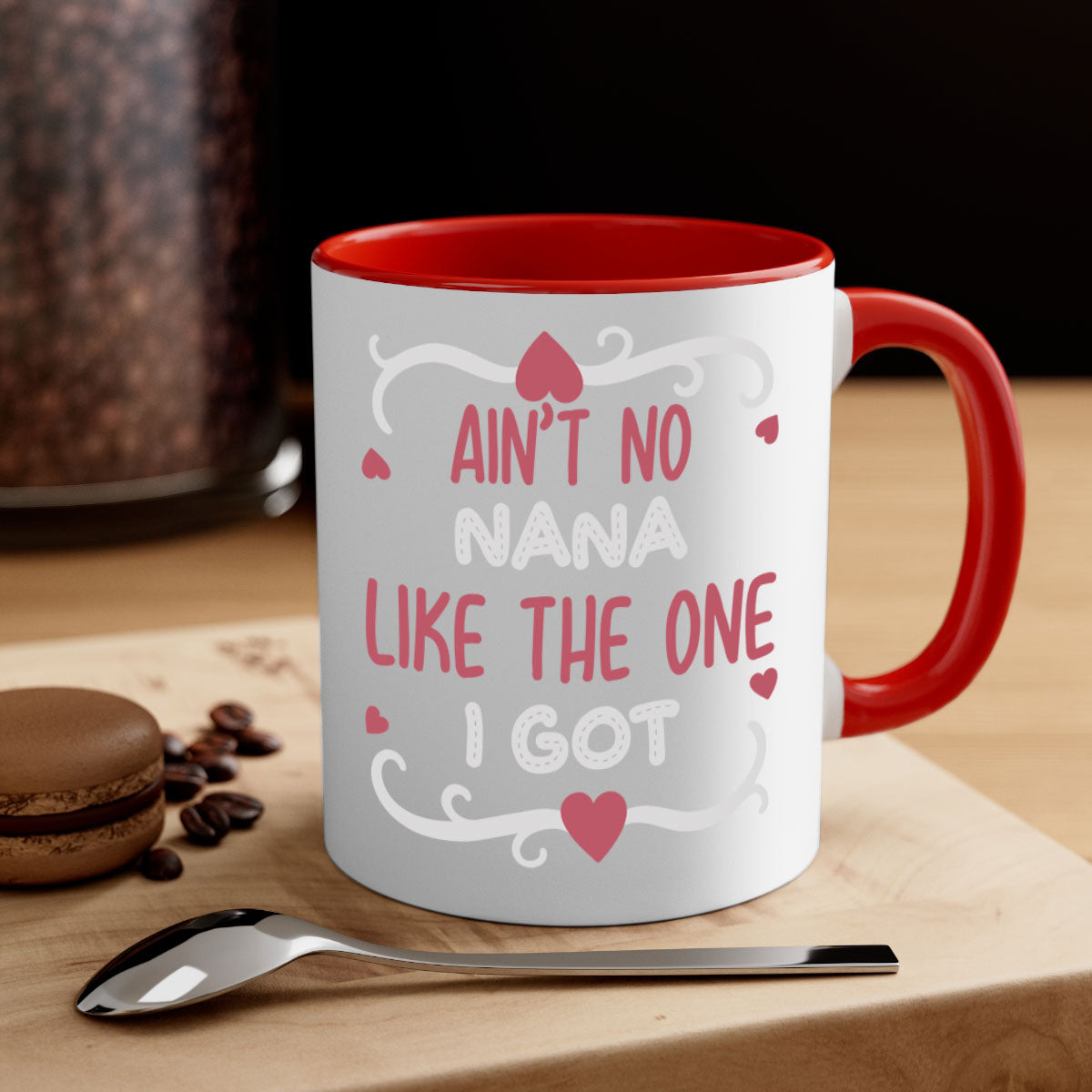 A stylish two-tone ceramic mug with a colored handle and interior, featuring the phrase 'Ain’t No Nana Like The One I Got'.