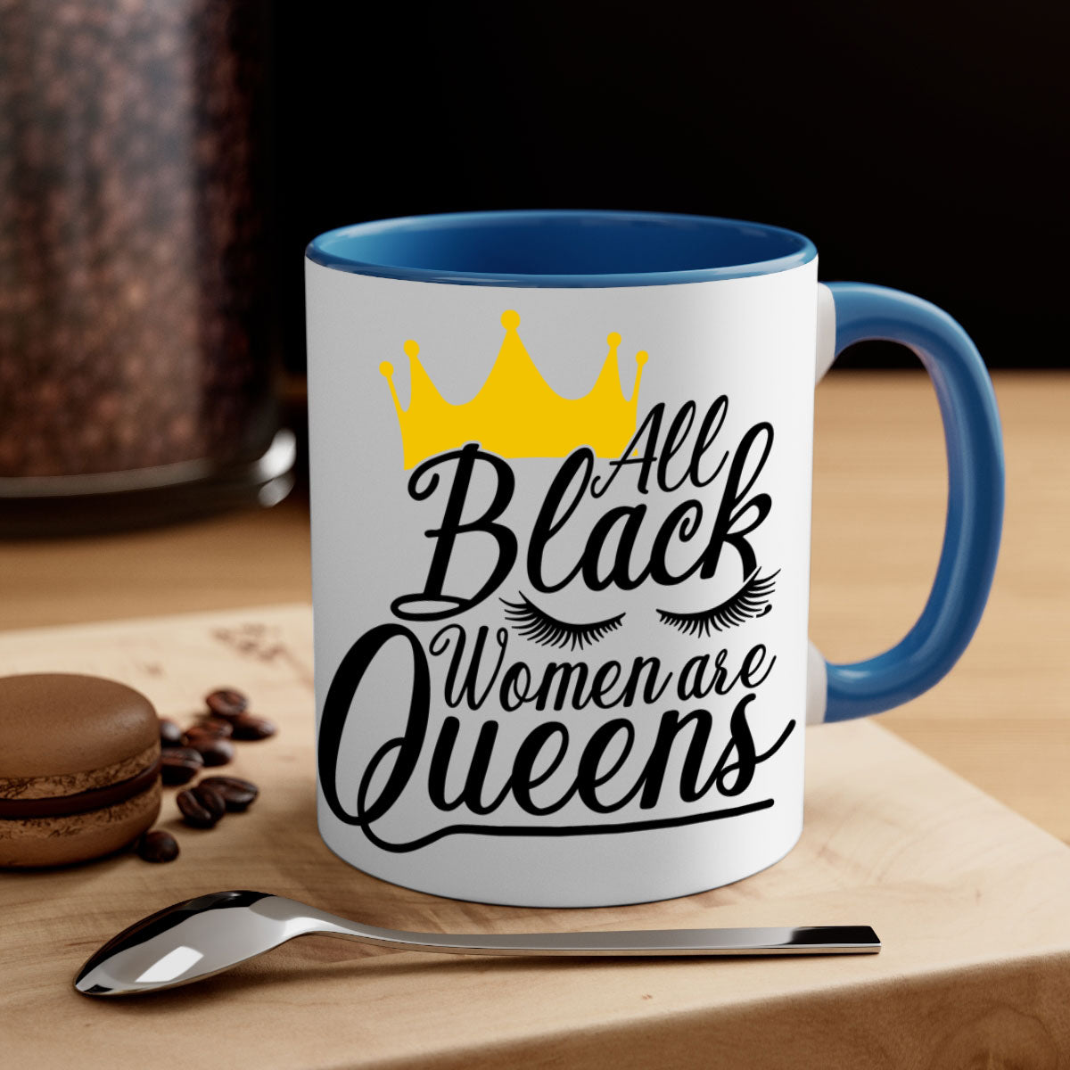 A stylish two-tone ceramic mug featuring the phrase 'All Black Women Are Queens' with a colored handle and glossy finish.