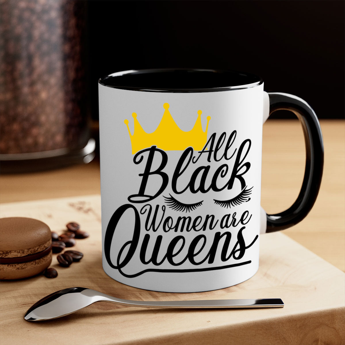 A stylish two-tone ceramic mug featuring the phrase 'All Black Women Are Queens' with a colored handle and glossy finish.