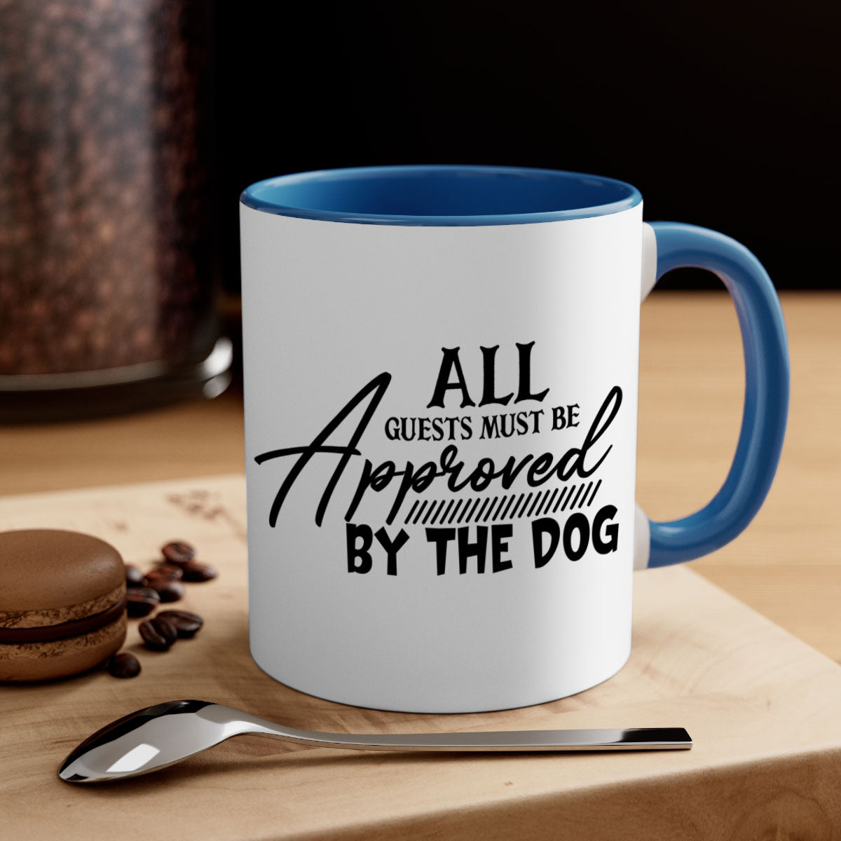 Ceramic coffee mug with a glossy finish featuring the phrase 'All Guests Must Be Approved by the Dog' in a playful font, available in multiple colors.