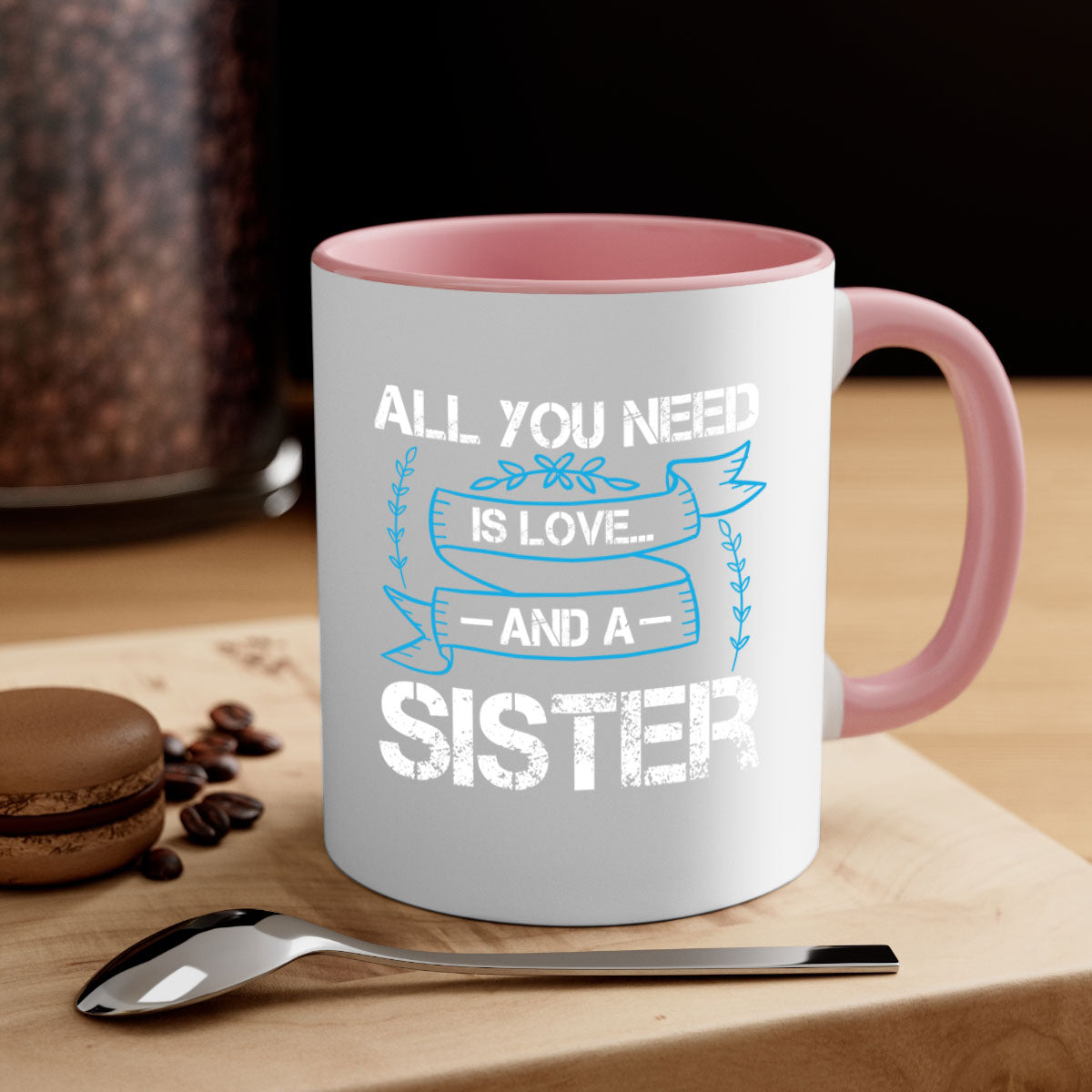 Ceramic mug with 'All You Need Is Love… and a Sister' design, featuring a two-tone color scheme and glossy finish.