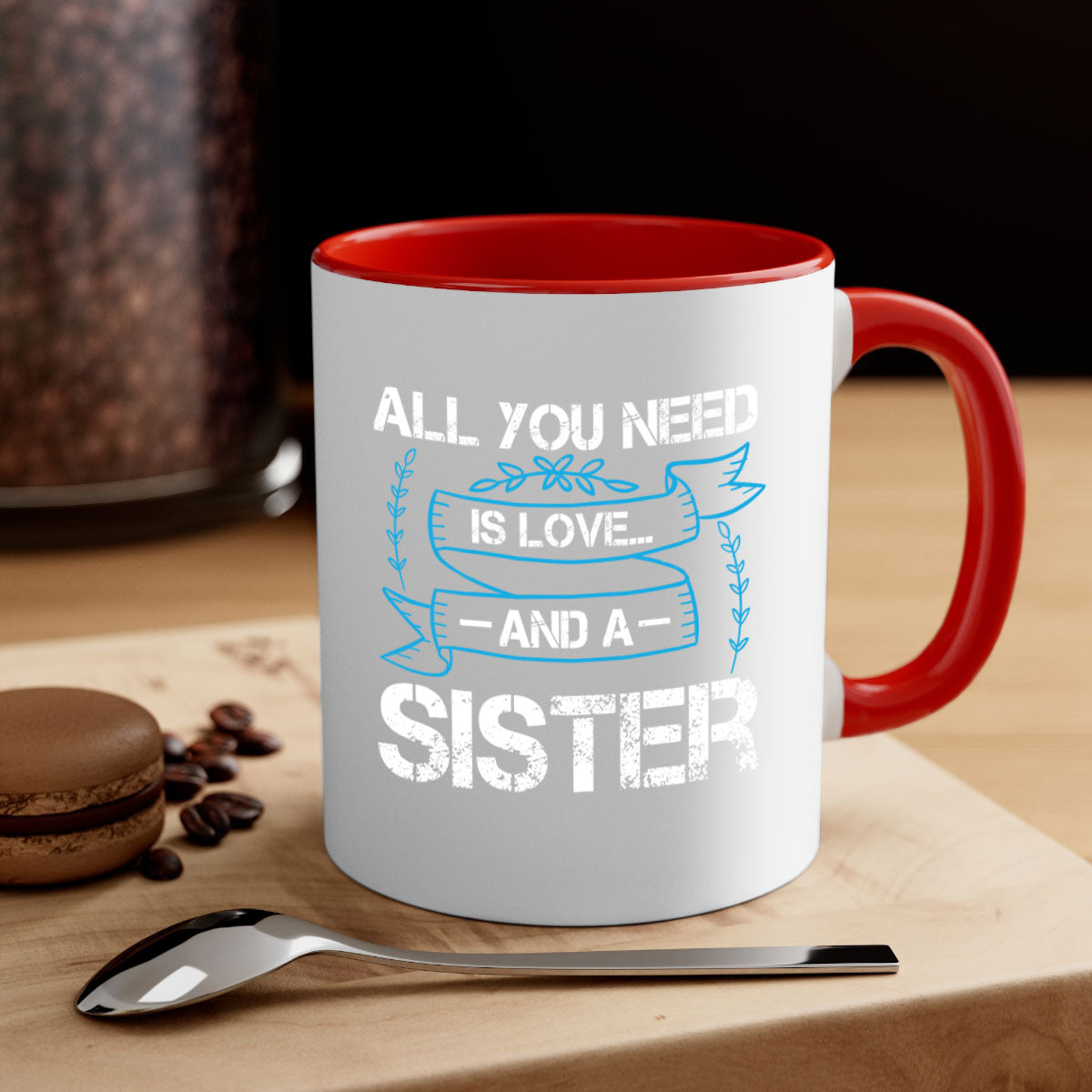 Ceramic mug with 'All You Need Is Love… and a Sister' design, featuring a two-tone color scheme and glossy finish.