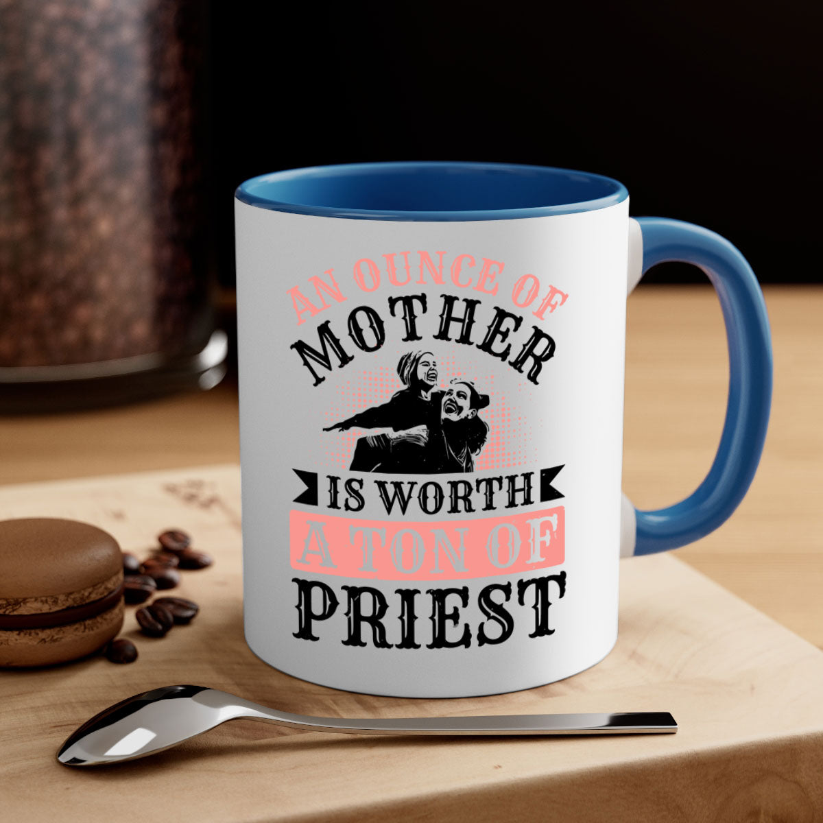 A two-tone ceramic mug with a colored handle and glossy finish, featuring the quote 'An Ounce of Mother is Worth a Ton of Priest'.