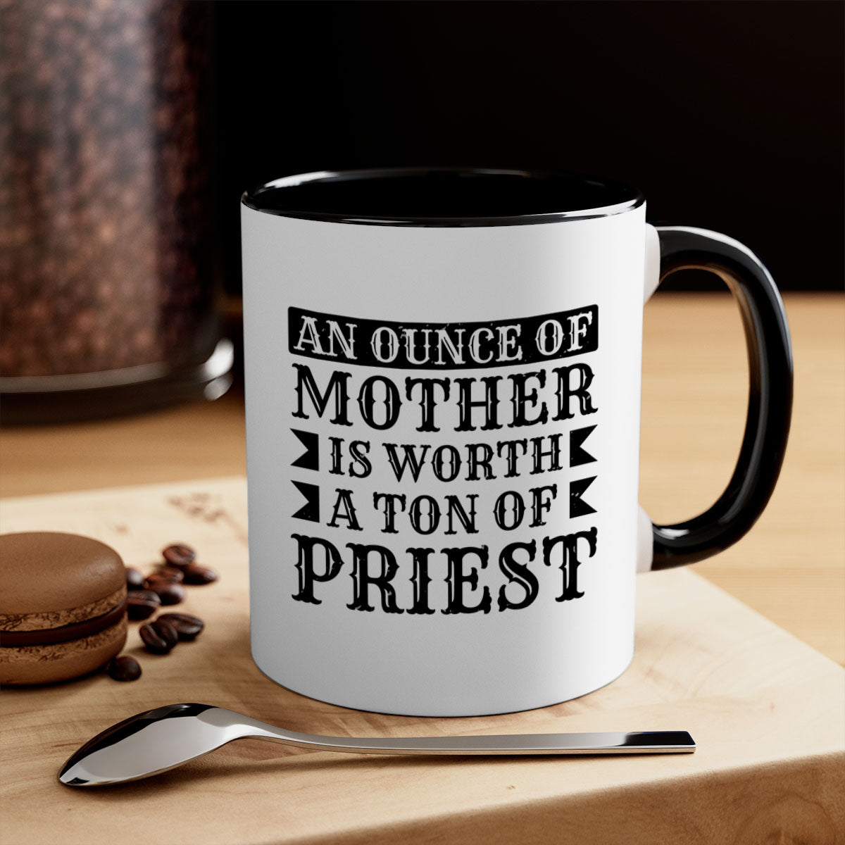Two-tone ceramic mug with colored handle and interior, featuring the phrase 'An Ounce of Mother is Worth a Ton of Priest'.
