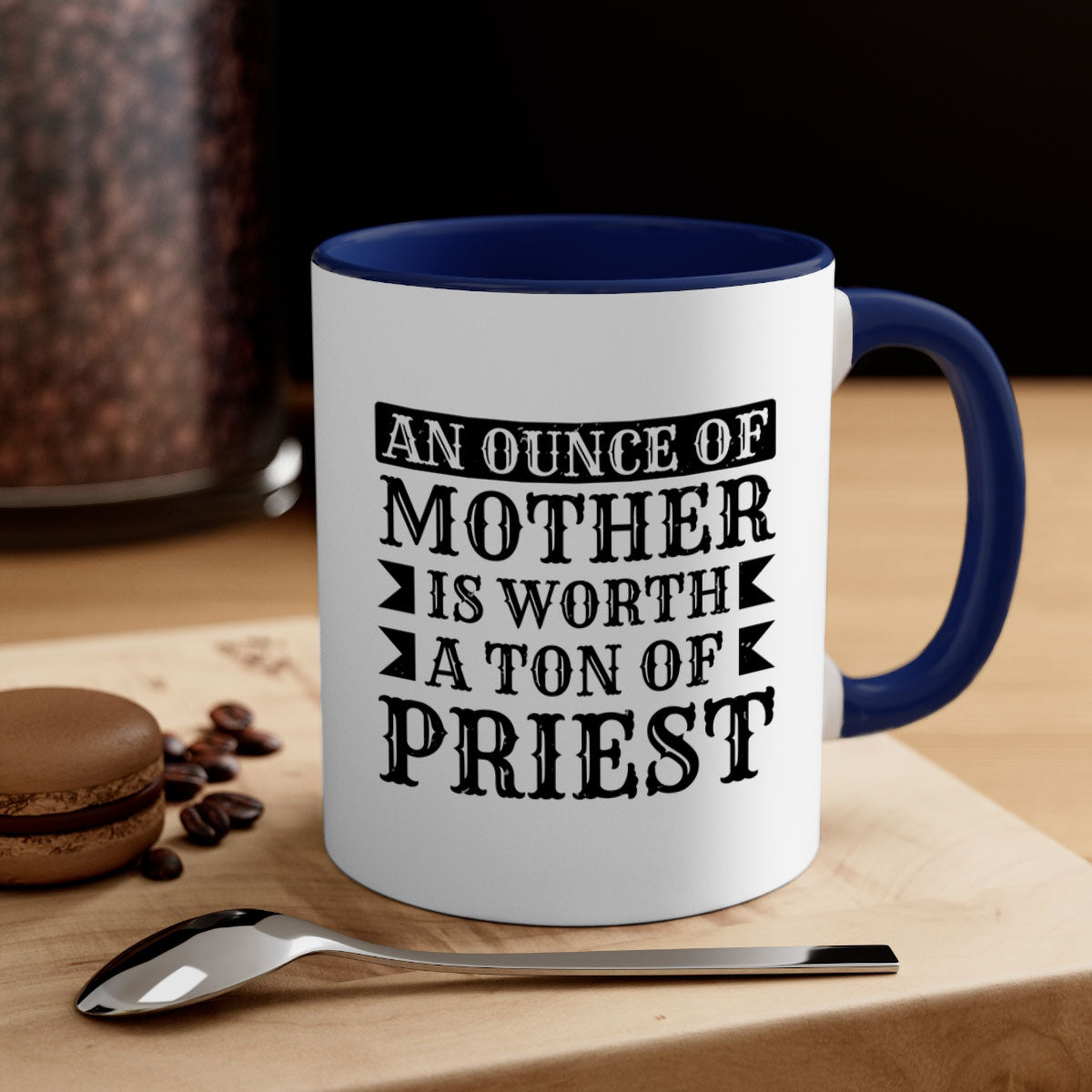 Two-tone ceramic mug with colored handle and interior, featuring the phrase 'An Ounce of Mother is Worth a Ton of Priest'.