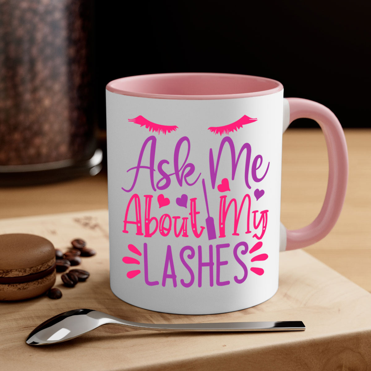 A stylish two-tone coffee mug with a colored handle and glossy finish, featuring the phrase 'Ask Me About My Lashes' in a chic design.