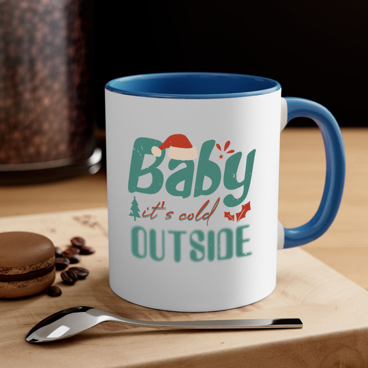 A stylish two-tone ceramic mug with the phrase 'Baby It's Cold Outside' printed on it, featuring a colored handle and glossy finish.